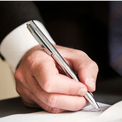 Hand client signing contract paper a real estate or mortgage contract. | Will writing service Harrow
